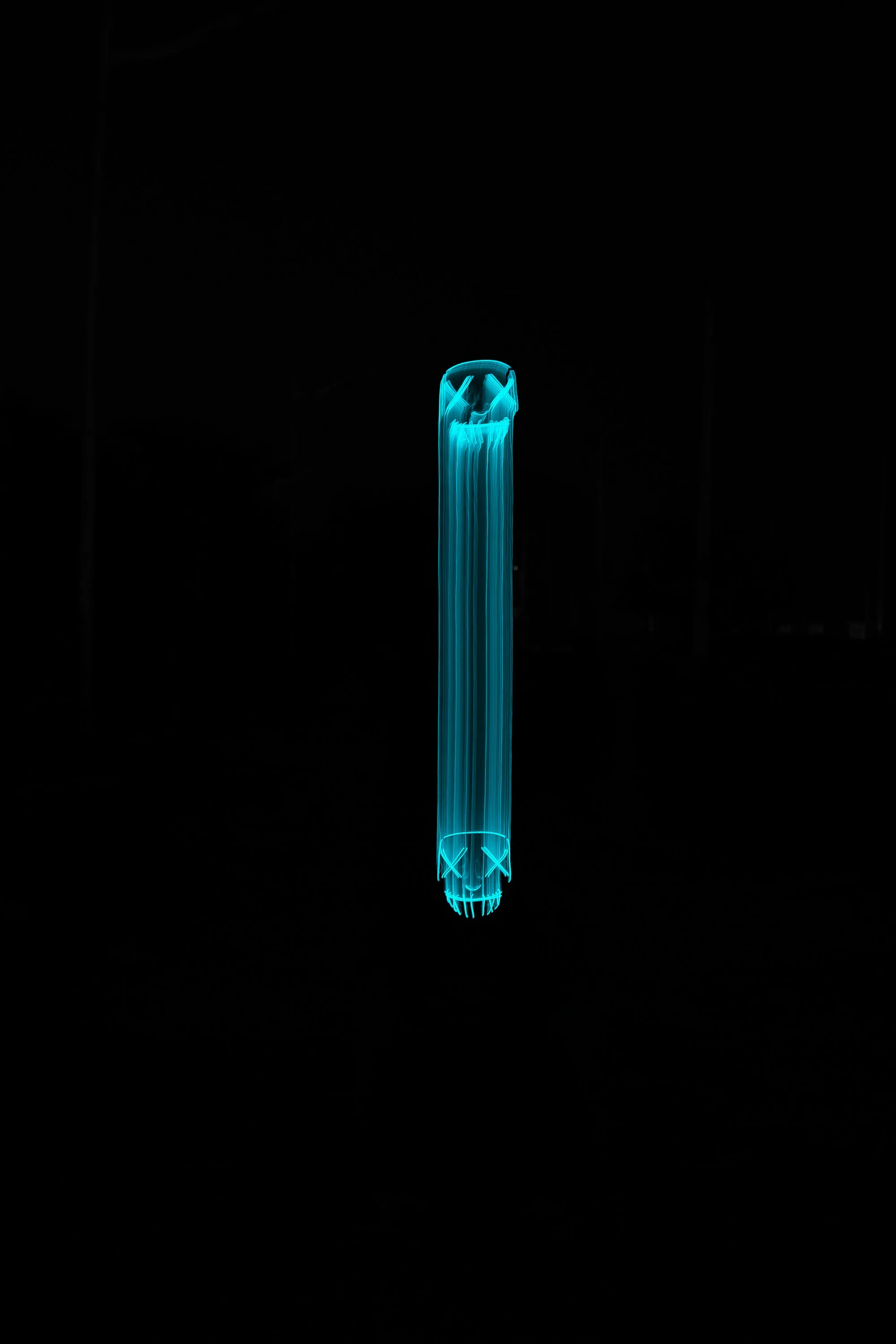 Ultraviolet lamp glowing cyan against a black background